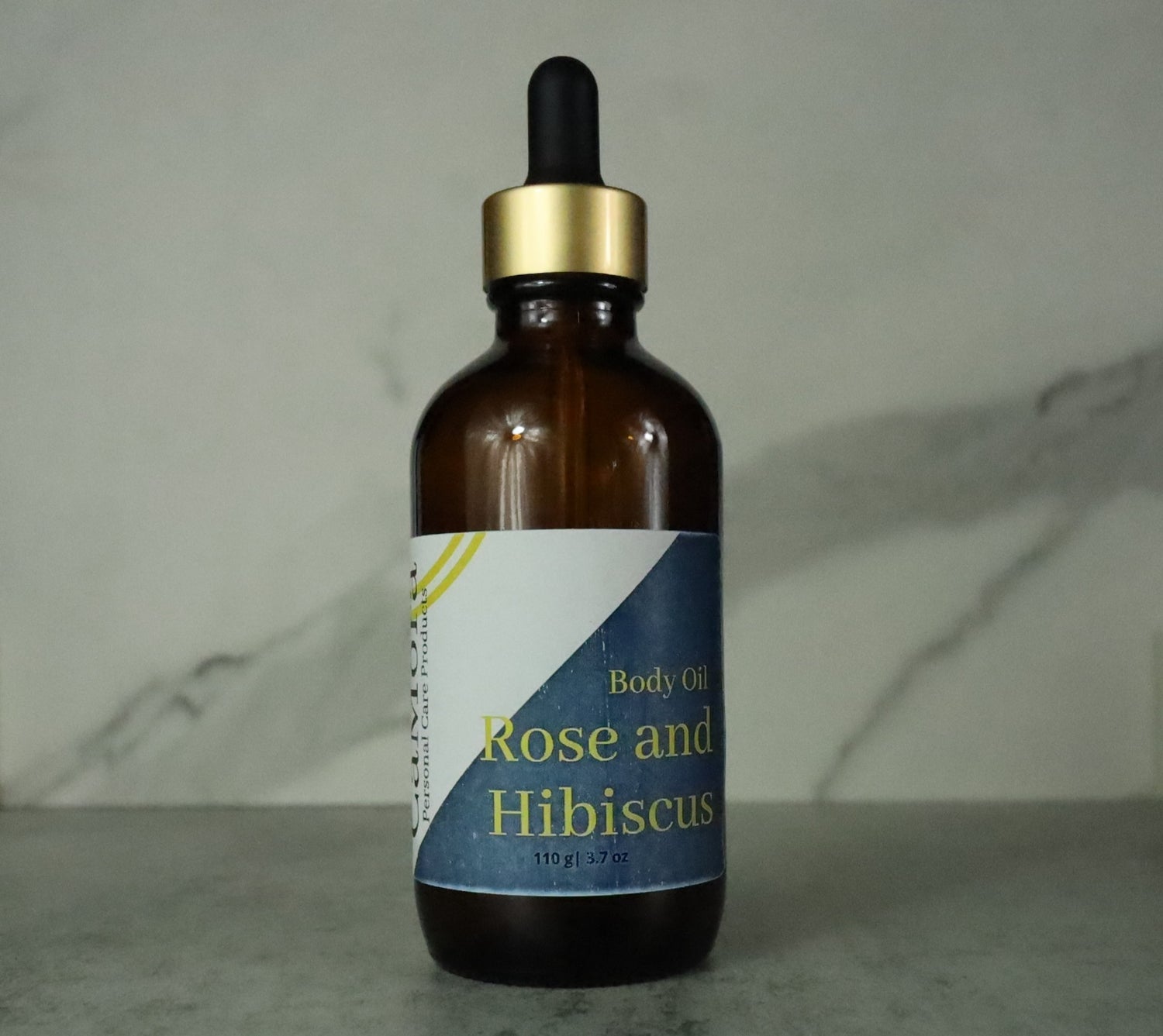 Ca'Mora Rose and Hibiscus Organic Body Oil collage of bottles.  4 ounce bottle.  Infused with organic roses and hibiscus leaves.
