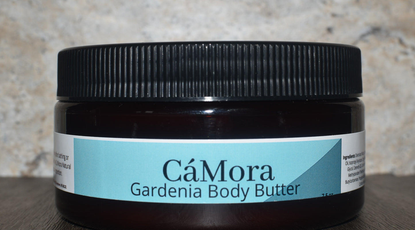 Jar of CóMora Gardenia Body Butter on a textured surface