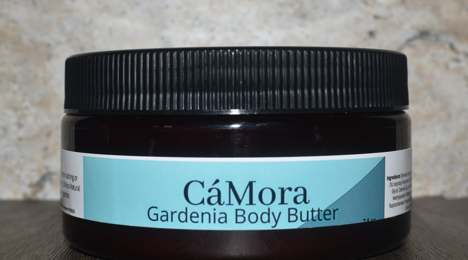 Jar of CóMora Gardenia Body Butter on a textured surface