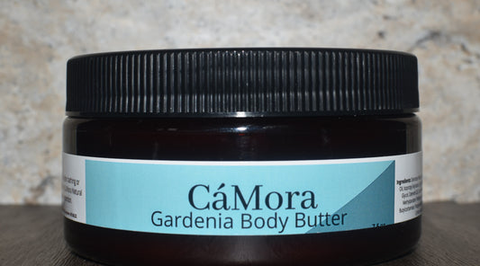 Jar of CóMora Gardenia Body Butter on a textured surface